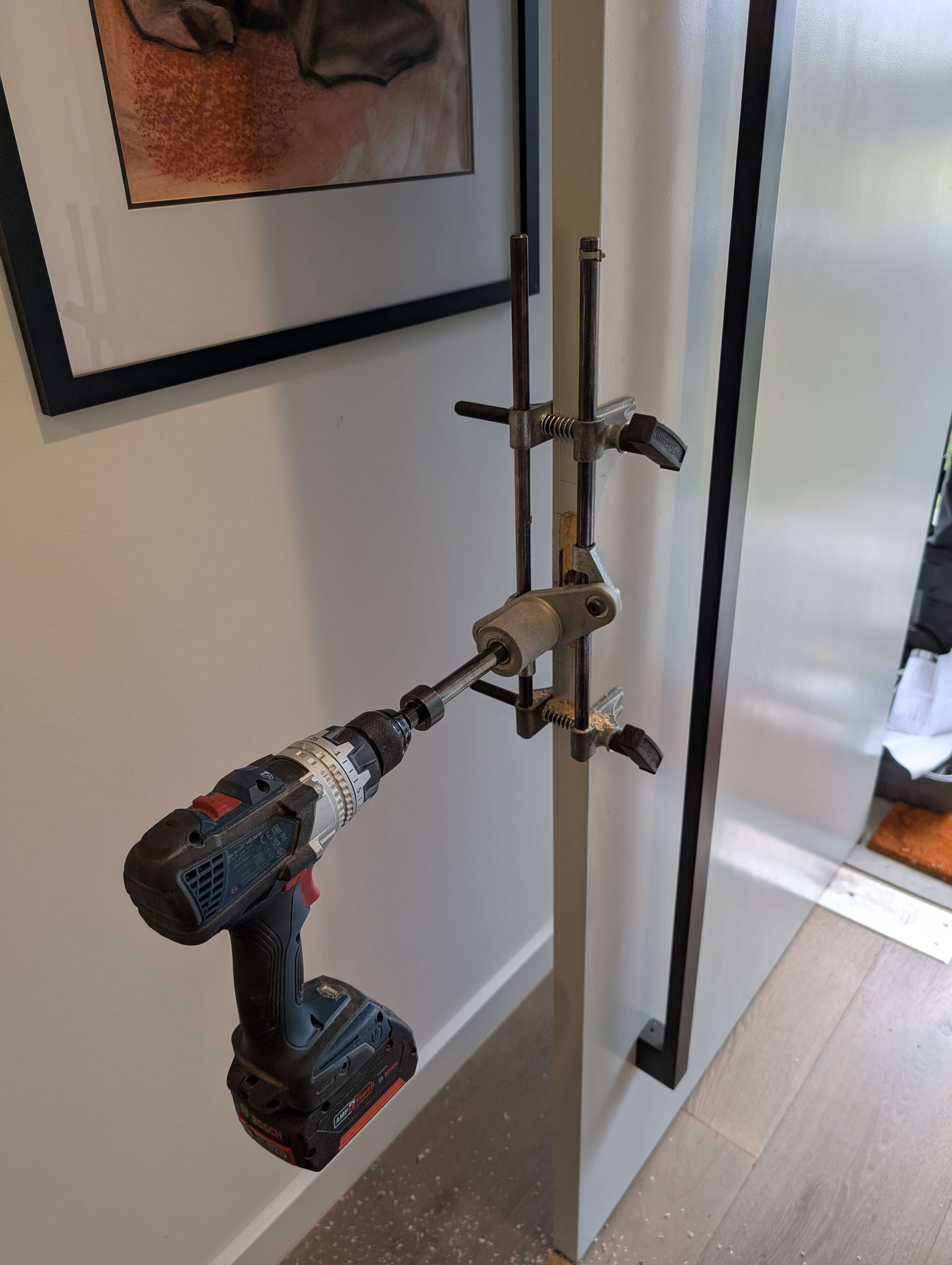 Vanguard locksmith installing a deadbolt with a drilling jig